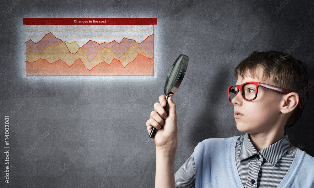 Curious school boy with magnifier