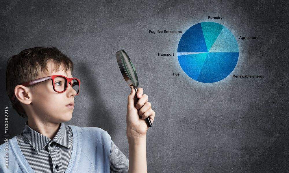 Curious school boy with magnifier