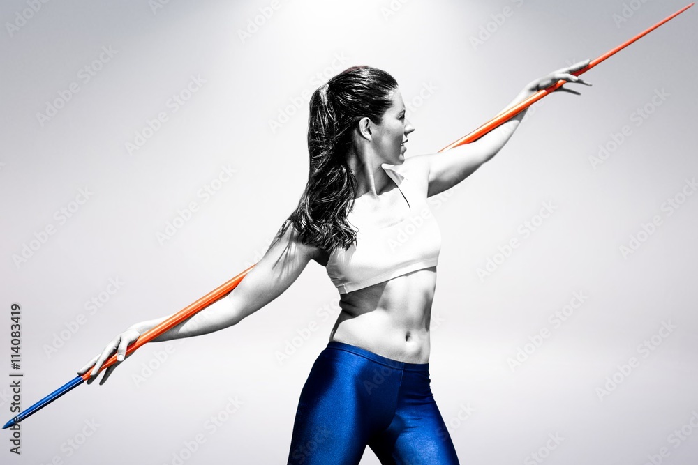 Composite image of sportswoman preparing to javelin throw 