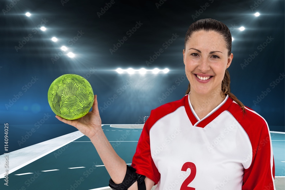 Composite image of sportswoman posing with ball