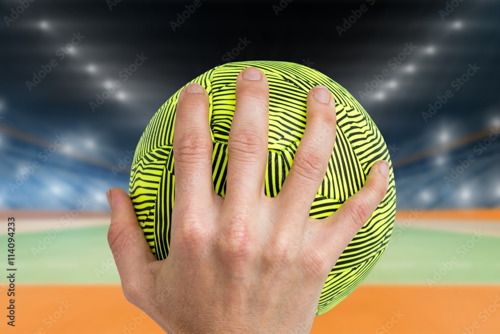 Composite image of sportswoman holding a ball