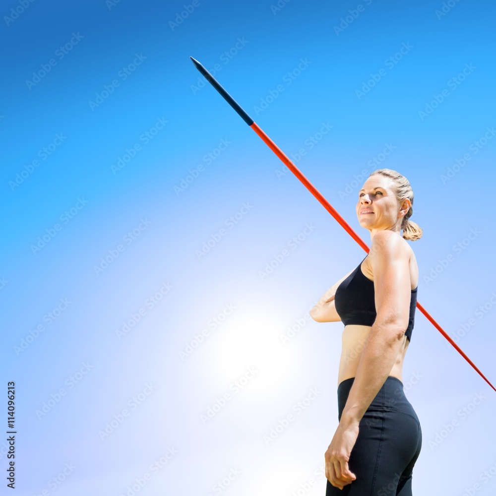 Sportswoman holding a javelin on a white background 