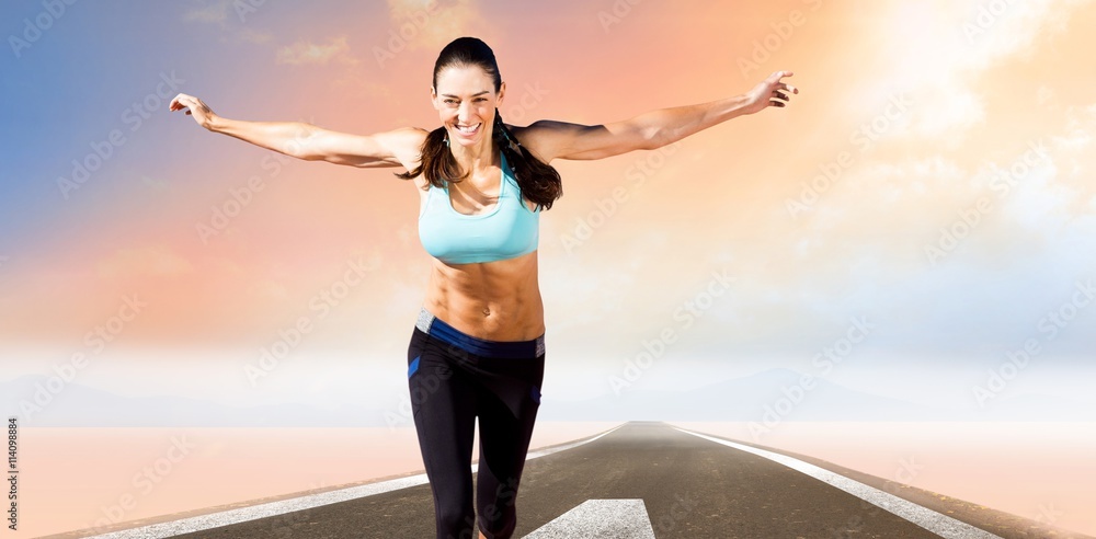 Composite image of happy sportswoman is raising arms 