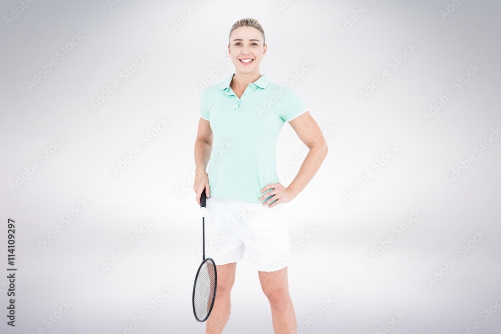 Composite image of badminton player is posing and smiling