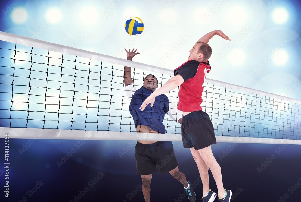 Composite image of sportsman hitting volleyball