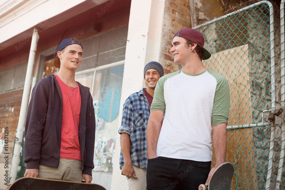 Guys skateboarders in street