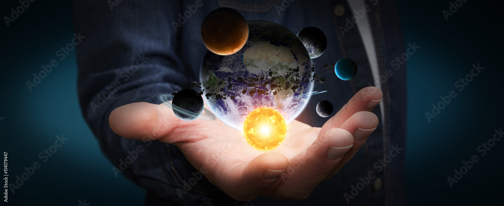 Businessman holding solar system in his hand