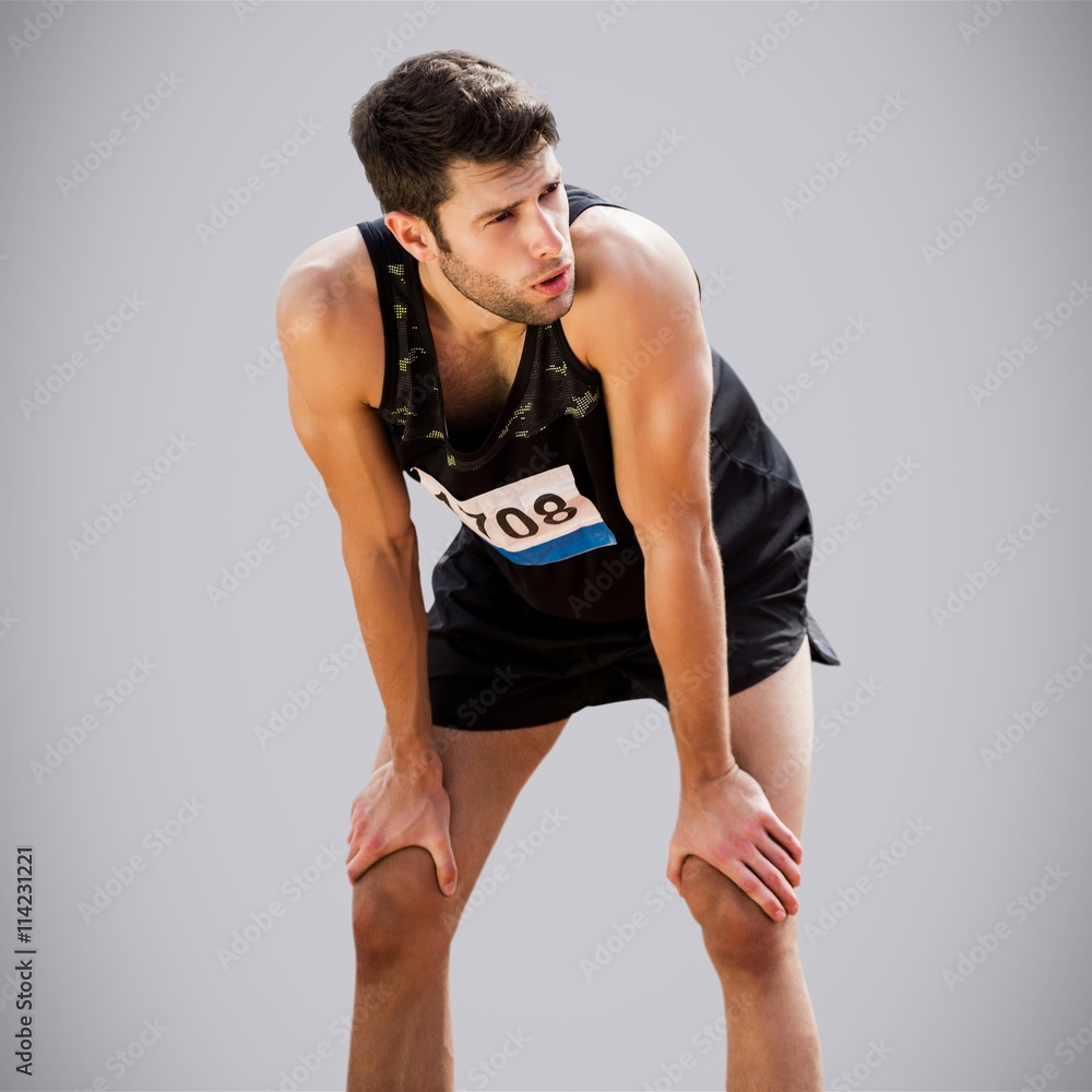 Composite image of athletic man resting with hands on knees