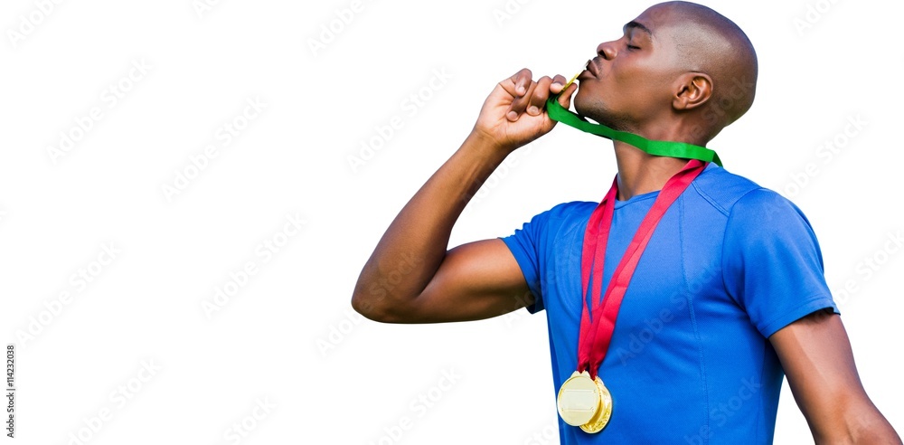 Profile view of winner kissing medals 