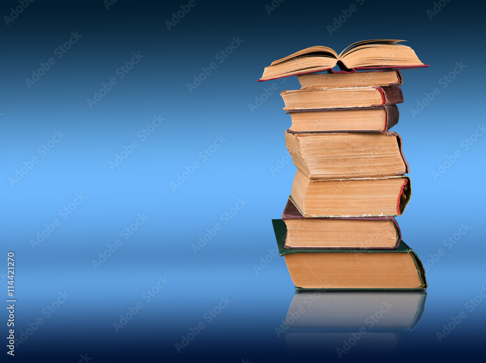 Stack of books on the color gradient background, space for text