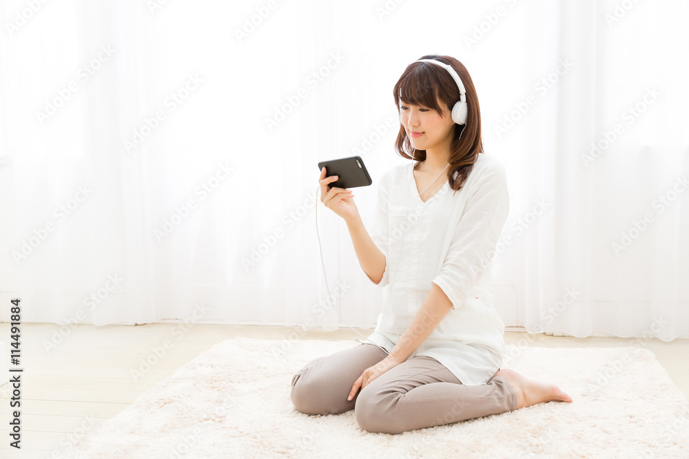 attractive asian woman listening music