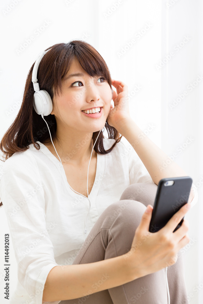 attractive asian woman listening music