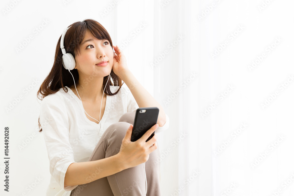 attractive asian woman listening music