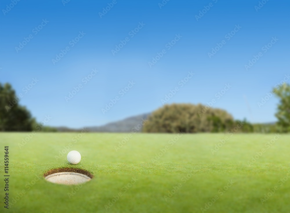 Golf ball at the edge of the hole