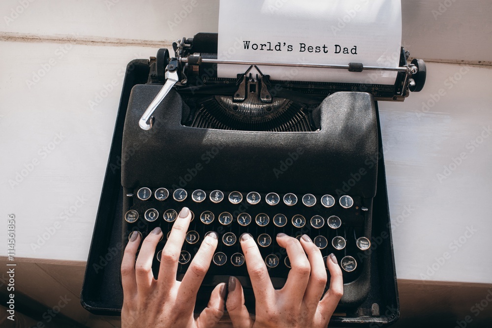 Hands typing on typewriter