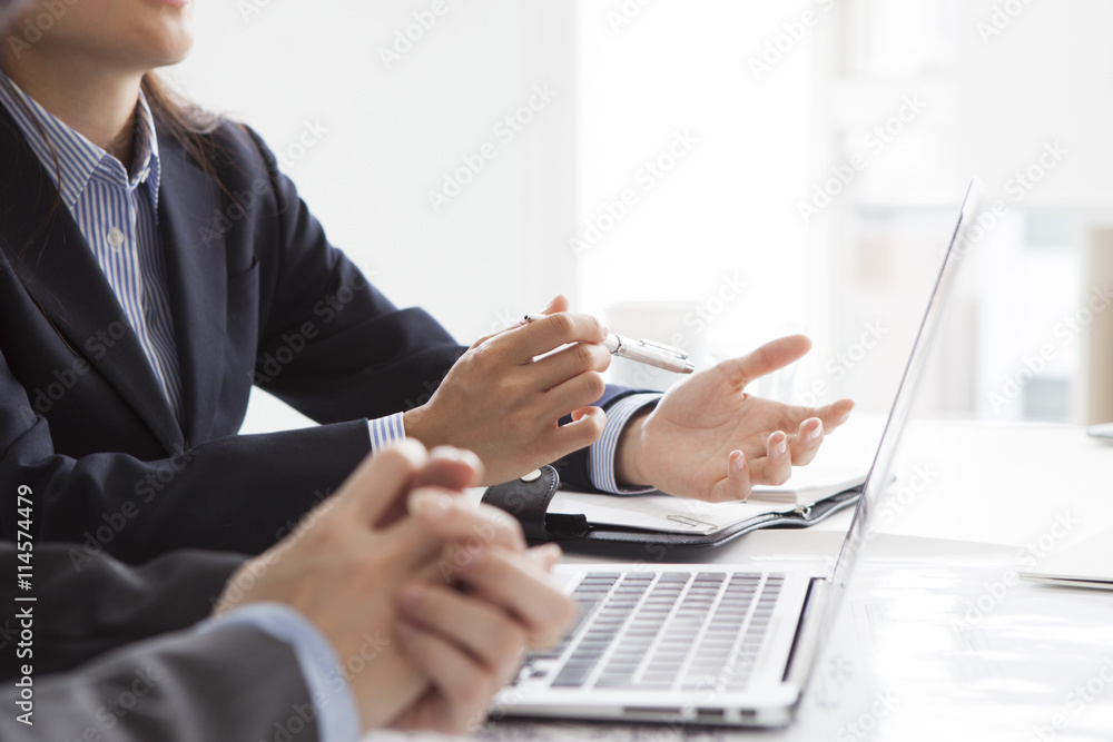 Two business woman is using a laptop in the office