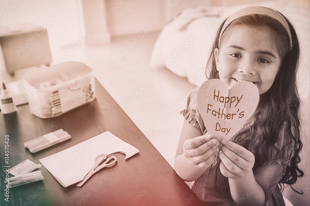 Young girl holding a Happy fathers day gift