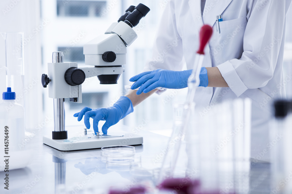 Women are conducting research using the microscope