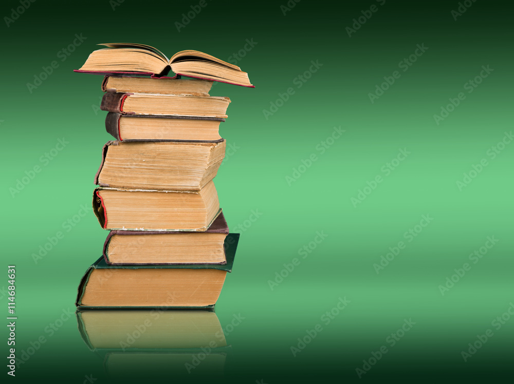 Stack of books on the color gradient background, space for text