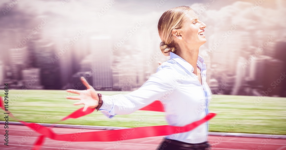 Composite image of successful businesswoman raising arms