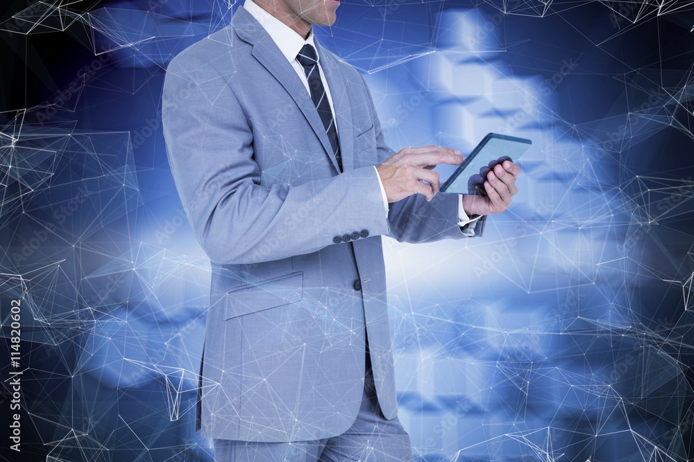 Composite image of businessman using tablet pc