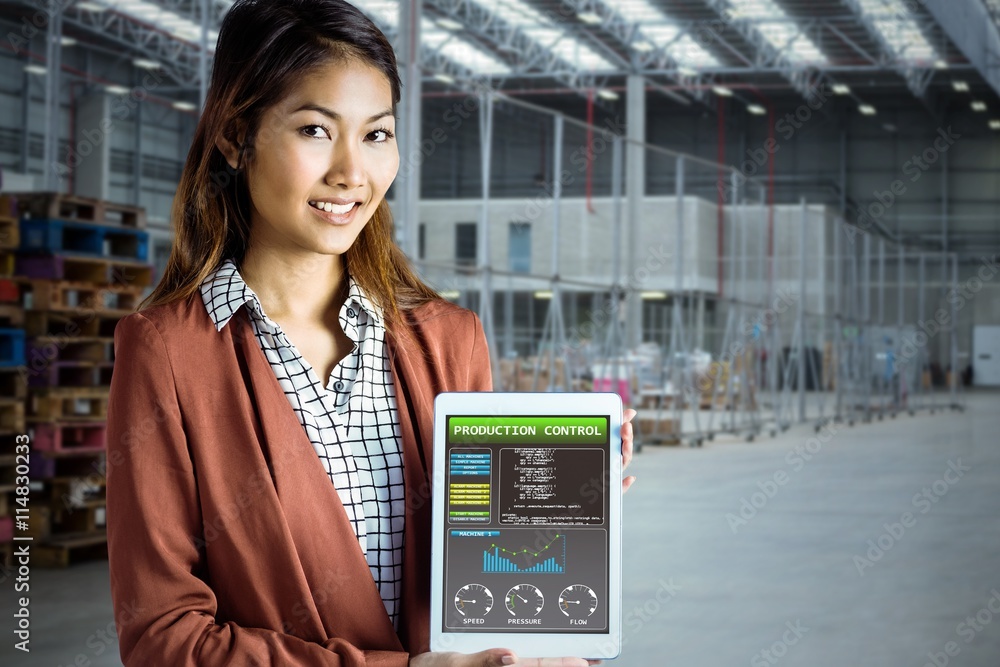 Composite image of smiling businesswoman showing a tablet