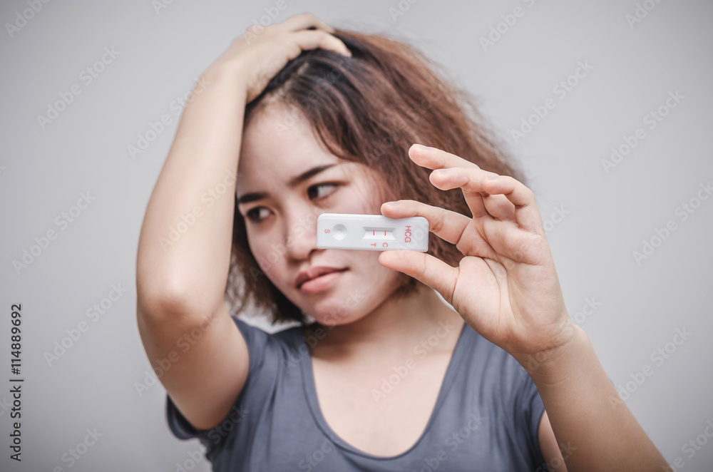 Young asian woman feel unhappy after know pregnancy test result