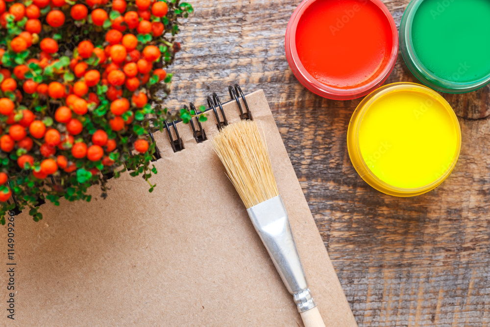 hobby painting workplace with colored gouache jars top view