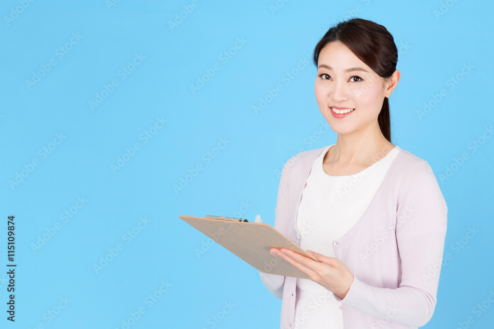 portrait of asian nurse isolated on blue background