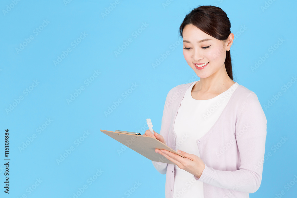 portrait of asian nurse isolated on blue background