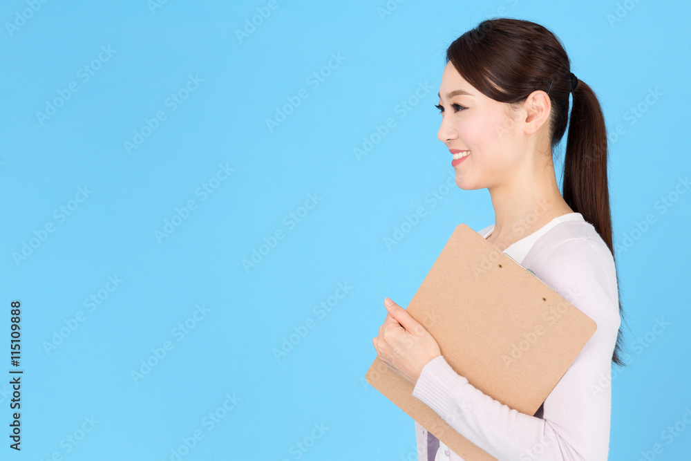 portrait of asian nurse isolated on blue background