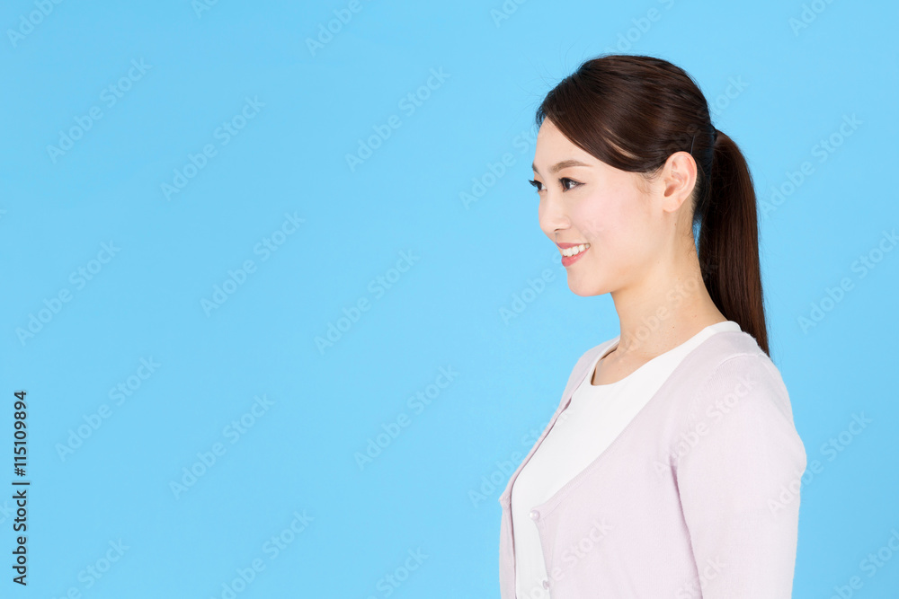 portrait of asian nurse isolated on blue background