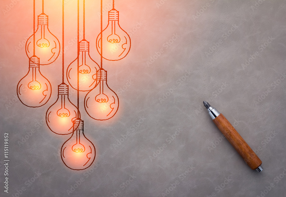 wooden pencil with drawing of glowing light bulb