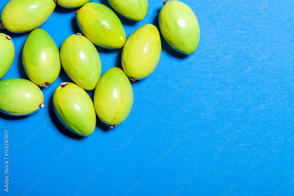 Group of olives on blue background with copy space, cooking concept