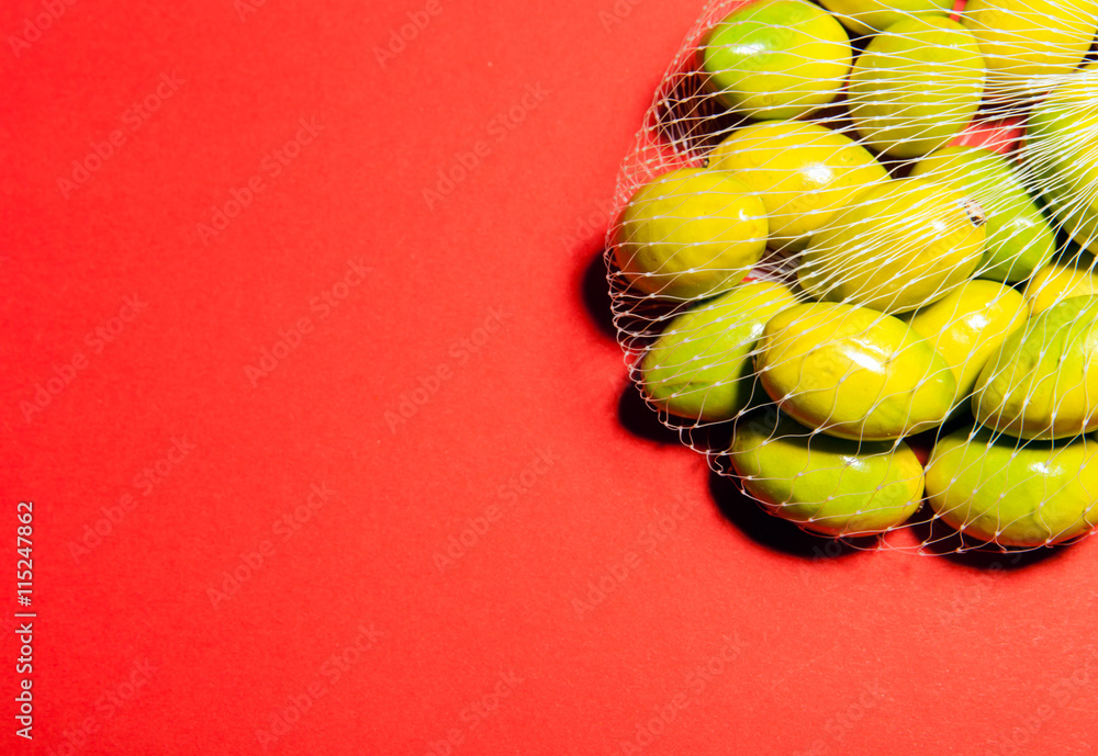 Green olives in the mesh bag, cooking concept