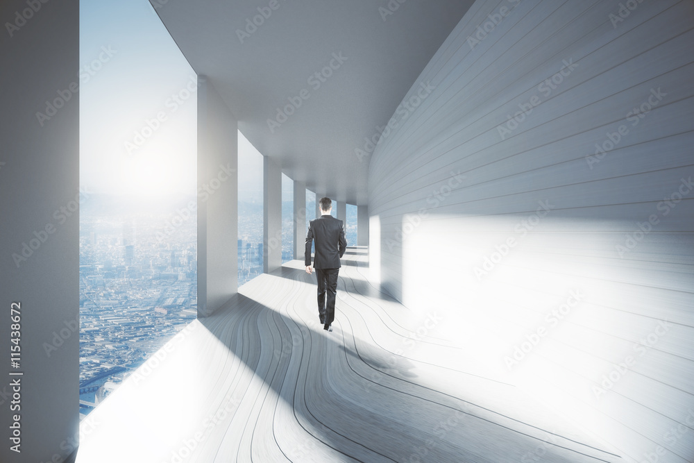 Businessman walking down corridor