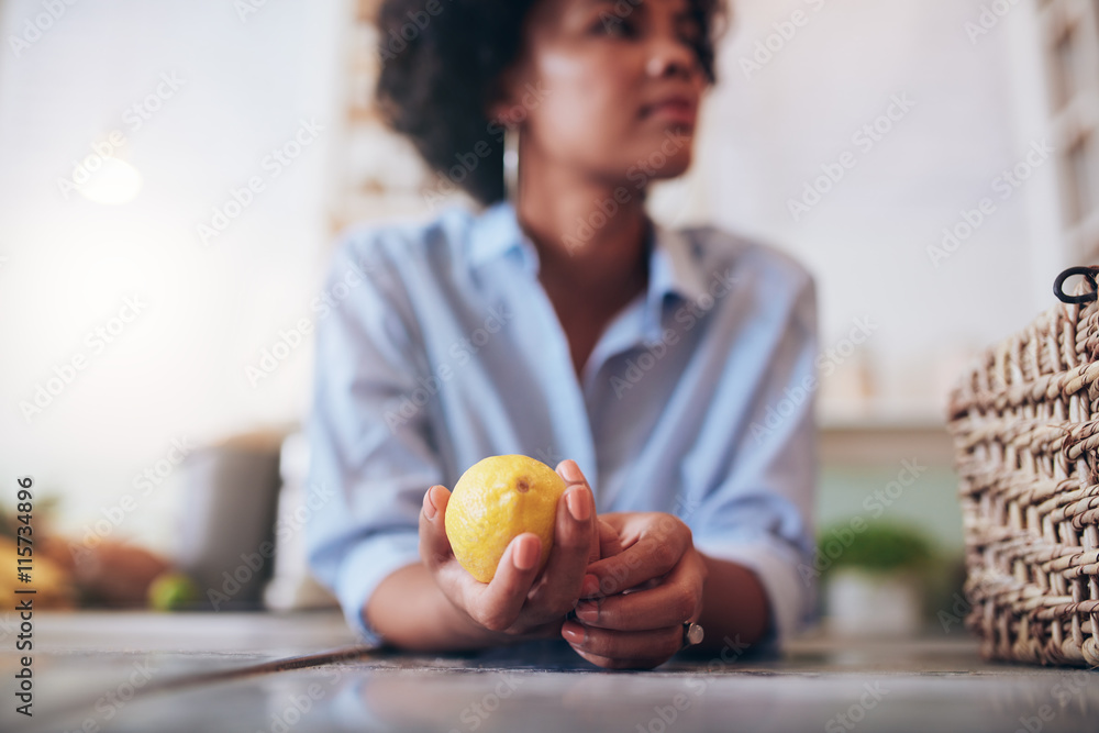 Woman at a juice bar counter with lemon