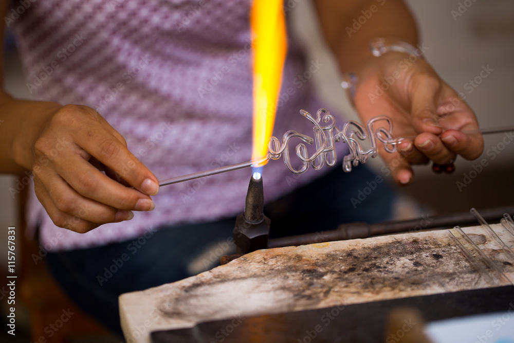 Asian people made hand craft grass blowing with fire blower