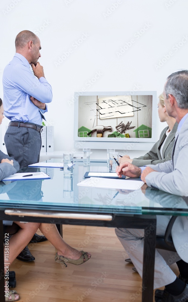 Composite image of business team looking at white screen