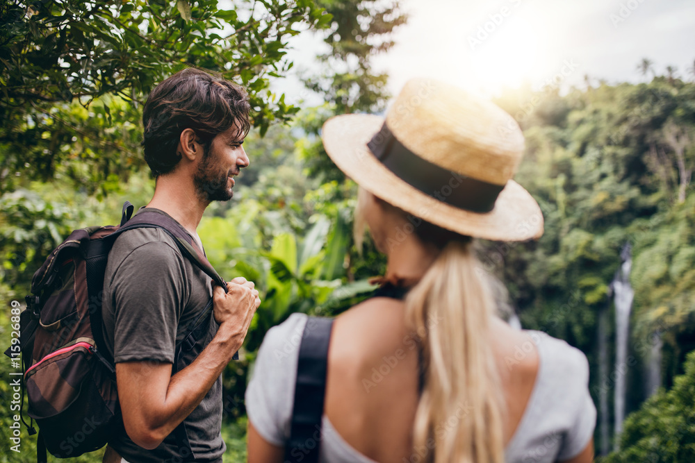 Young man standing with his girlfriend in forest