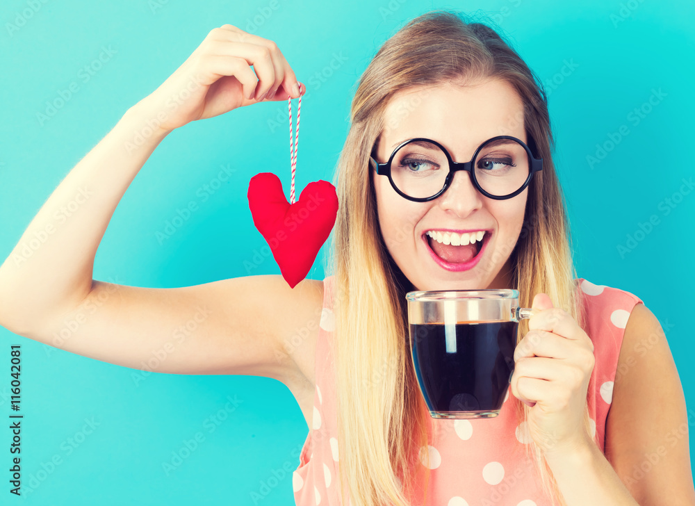 Woman drinking coffee with a heart cushion