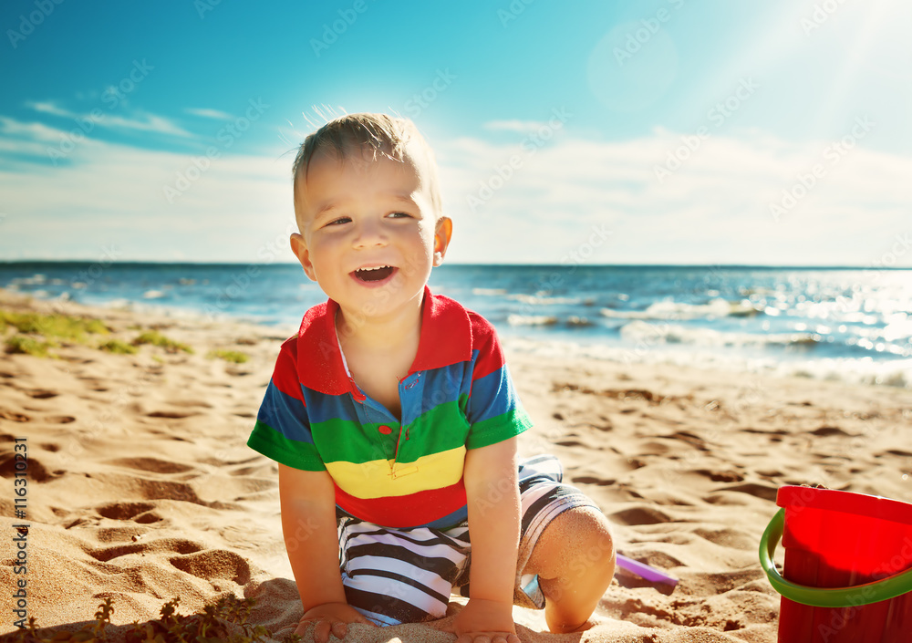 little boy smiling at the beach