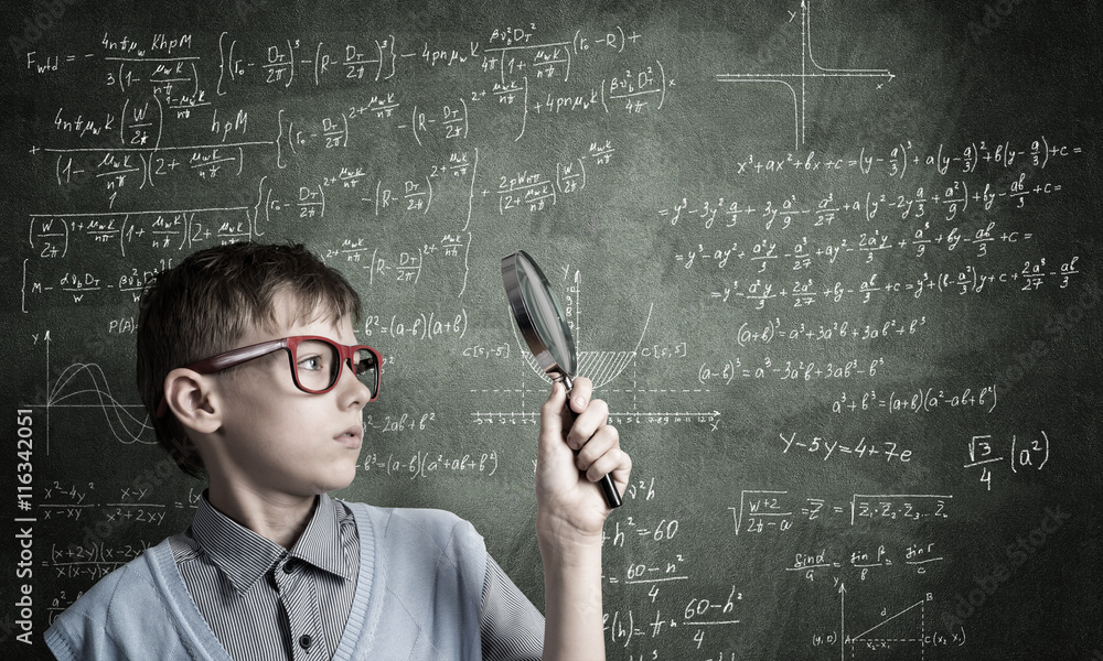 Curious school boy with magnifier