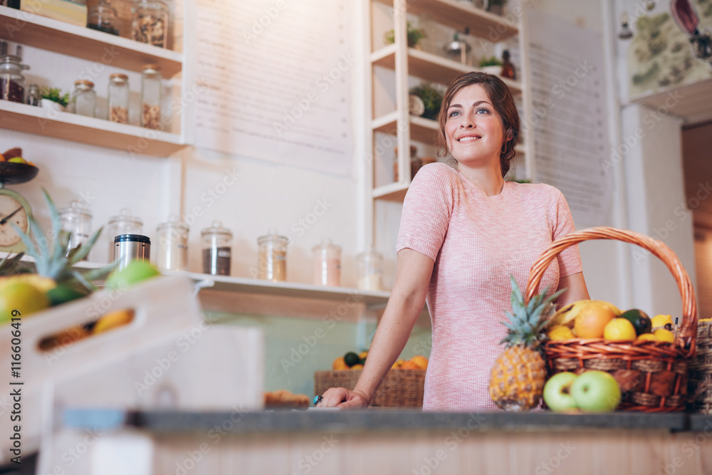 Young woman working at a juice bar