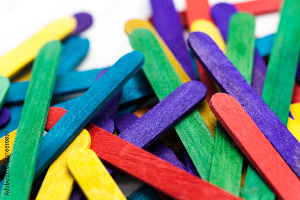 Colorful popsicle sticks over white background (Shallow depth of field)