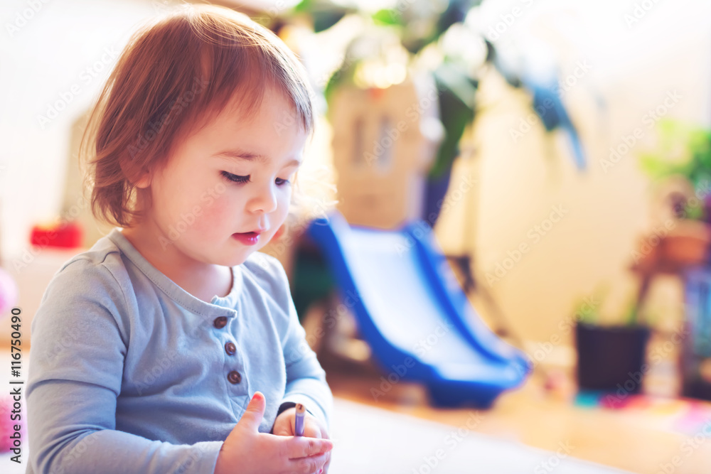 Toddler girl playing in her house