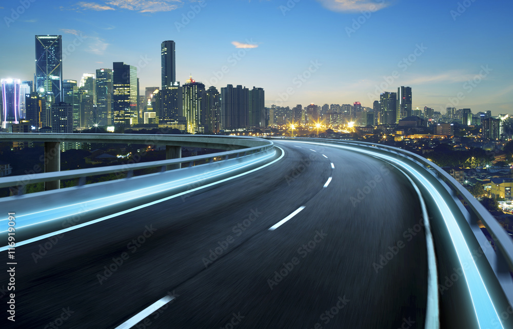 Highway overpass motion blur with city background .