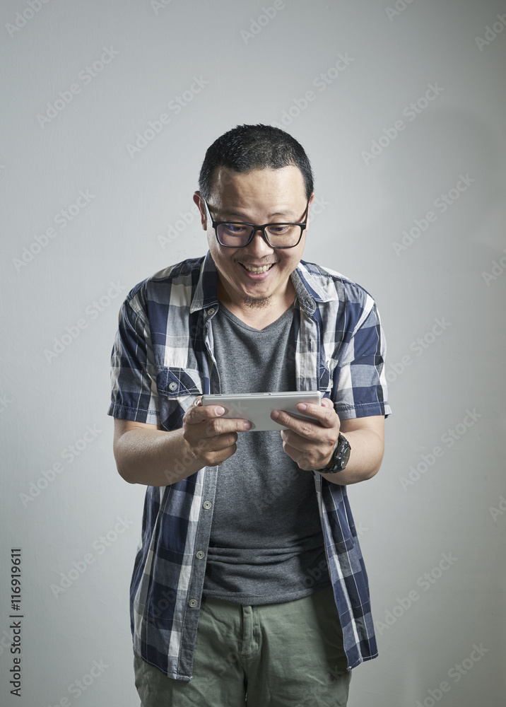 Excited asian man holding a smart phone