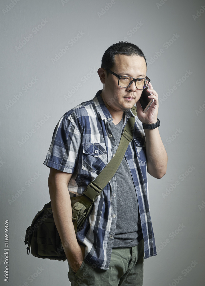 portrait of young asian man talking on the phone