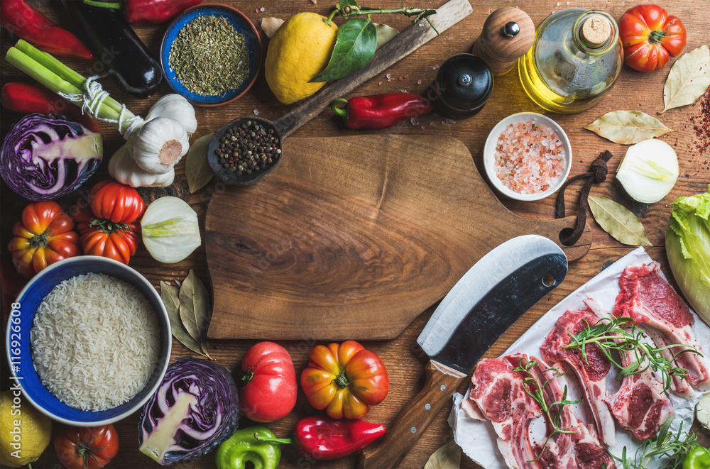 Ingredients for cooking dinner. Raw uncooked lamb meat chops, rice, oil, spices and vegetables over 